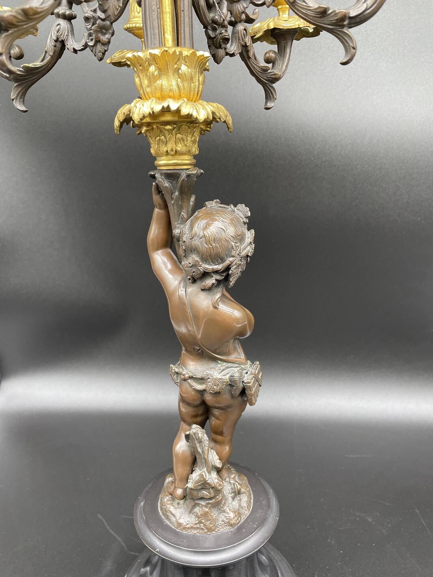 Candelabra with cherub in patinated bronze