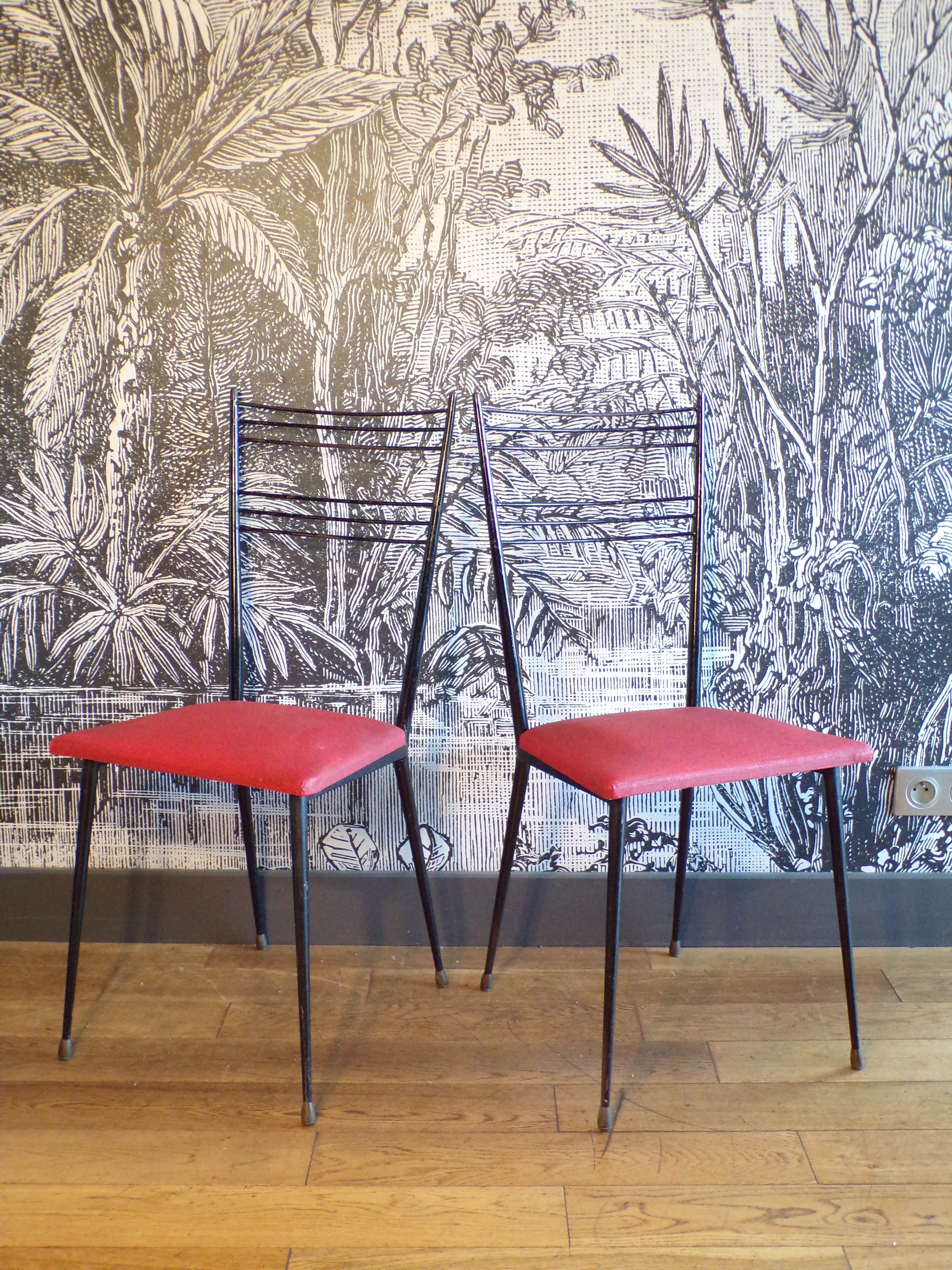Pair of red Colette Guéden chairs