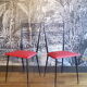 Pair of red Colette Guéden chairs