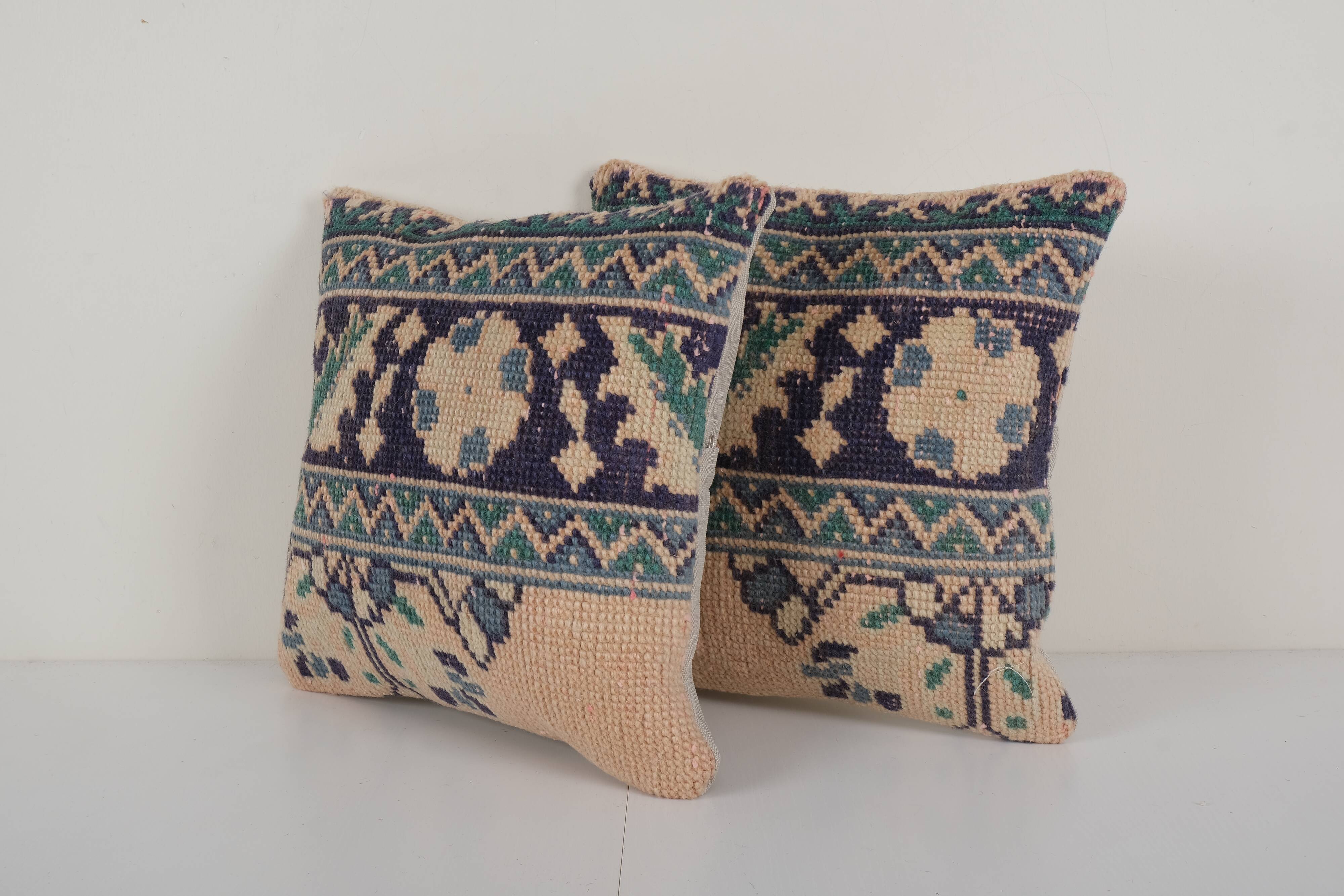 Set of two muted ecru carpet rug pillows