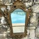 Carved and gilded wooden wall mirror.
