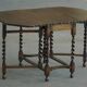 Antique baroque dining table in oak, with folding legs and drop leaves, featuring spiral "barley twist" legs, from the 1920s.