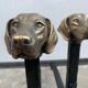 Pair of metal chenets decorated with brass dog heads