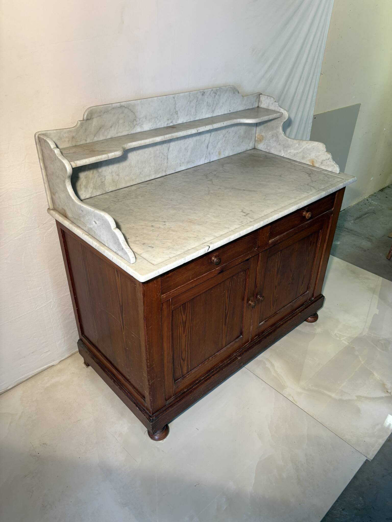 Antique wood and marble kitchen sideboard with carved backsplash