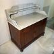 Antique wood and marble kitchen sideboard with carved backsplash