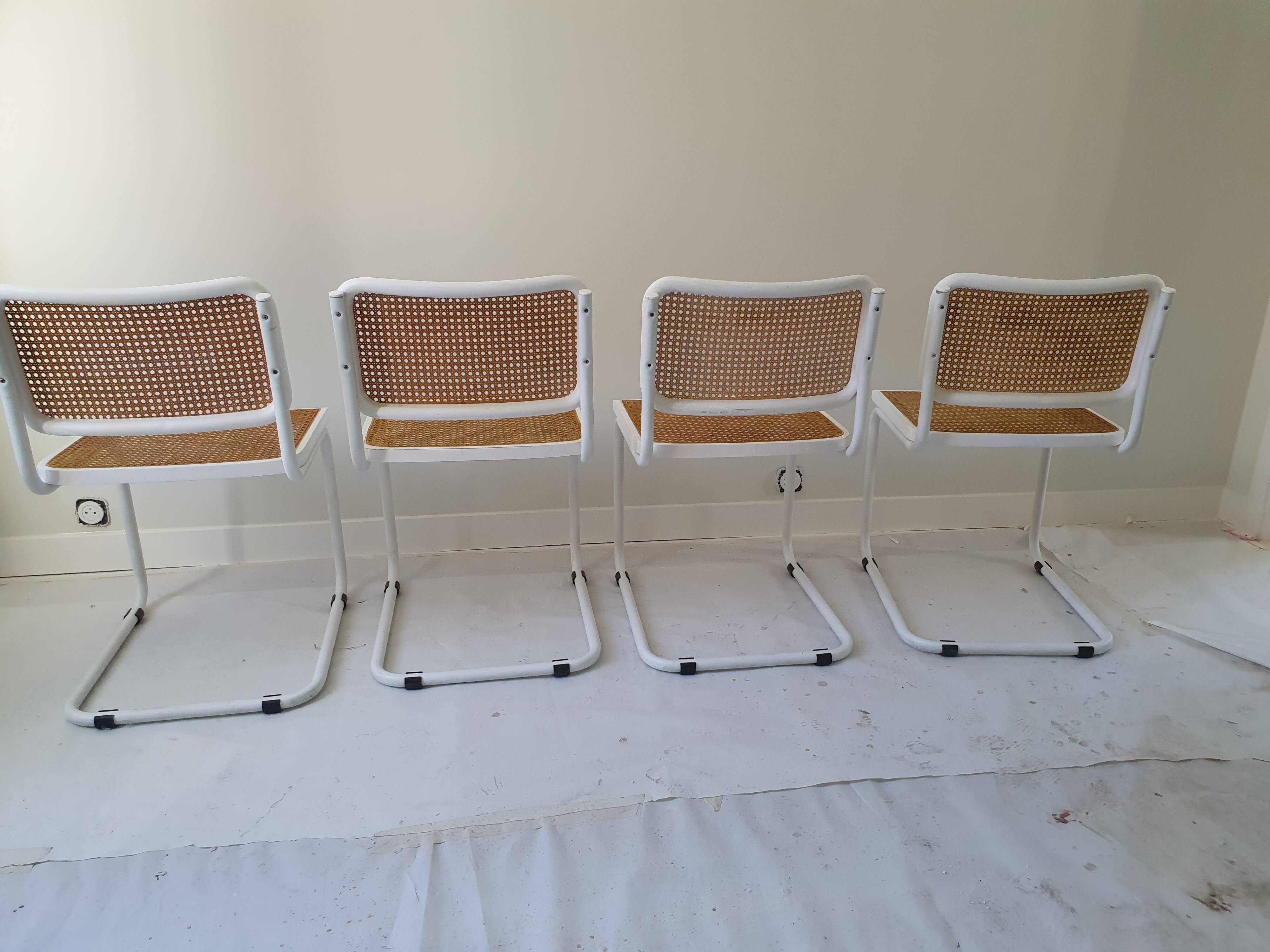 B32 chairs by Marcel Breuer in white.