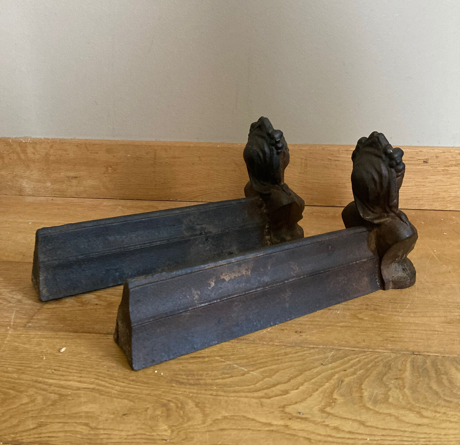Pair of cast iron andirons from the 19th century, busts of women