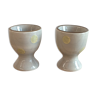 Two beige/greige ceramic egg cups with large yellow polka dots