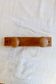Vintage wooden coat rack with two round hooks.