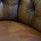 Antique, characteristic sheepskin chesterfield club chair on wheels
