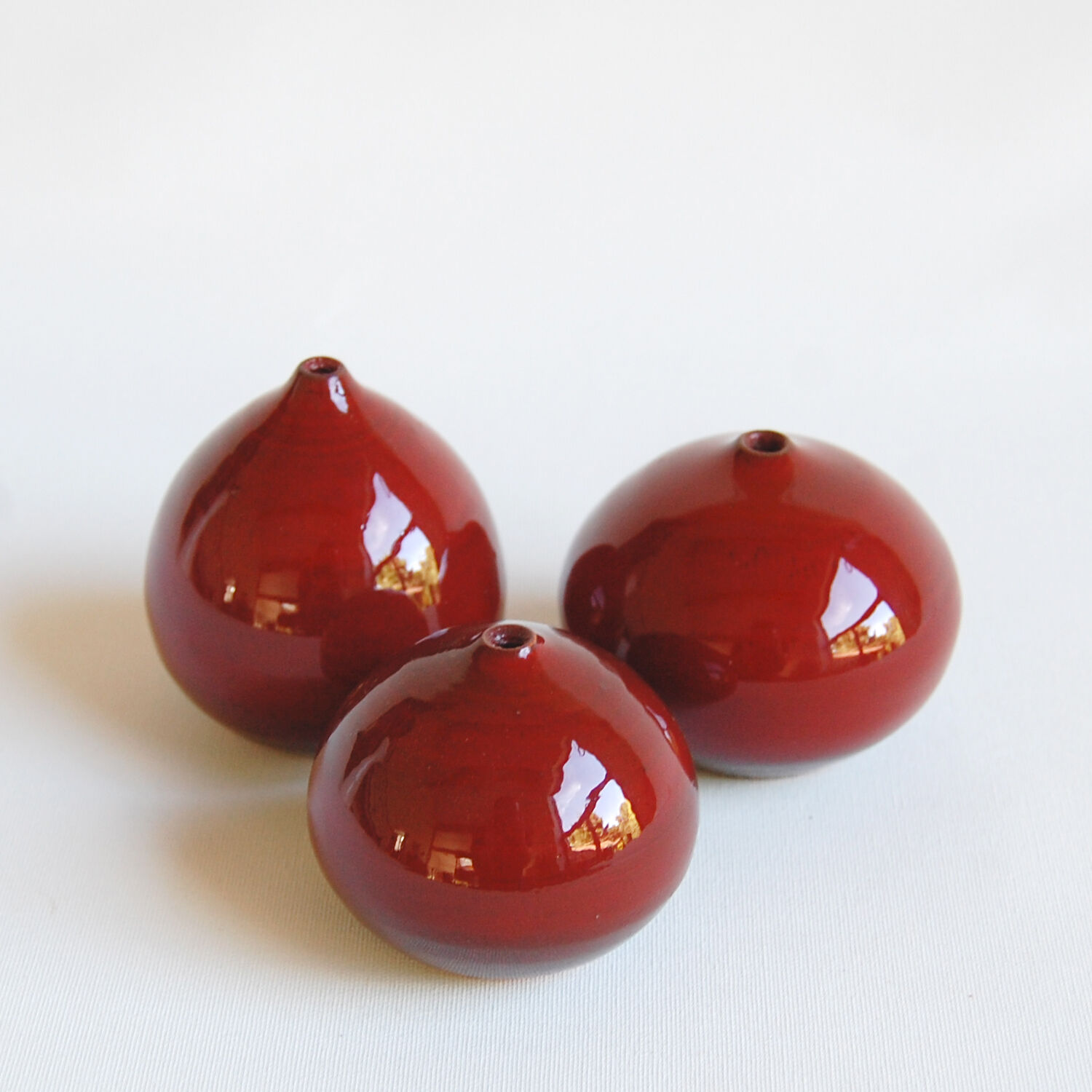 Trio of red miniature ceramics by Antonio Lampecco