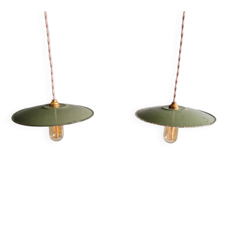 Pair of industrial pendant lights in green enamelled sheet metal.