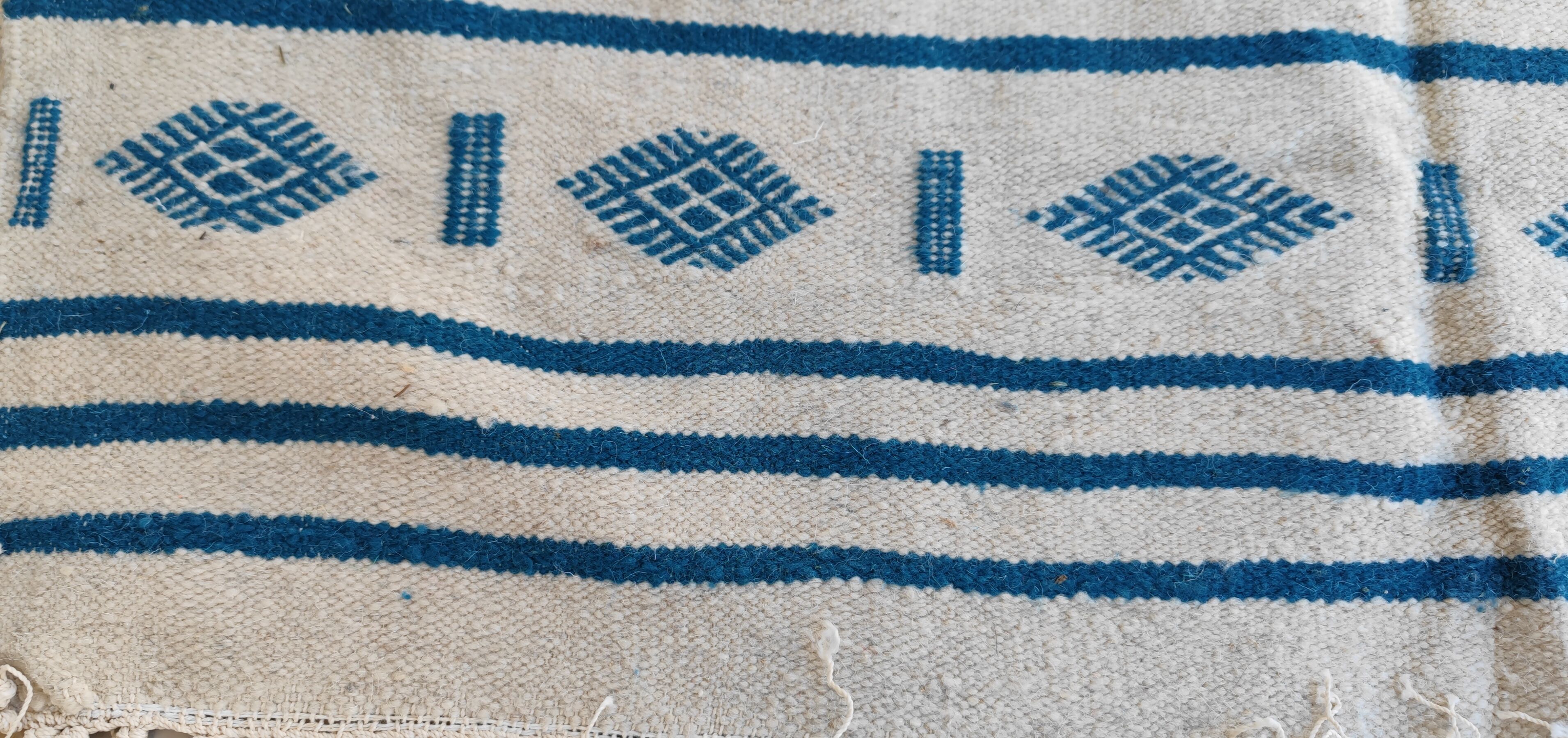 Traditional handmade white and blue kilim rug in natural wool