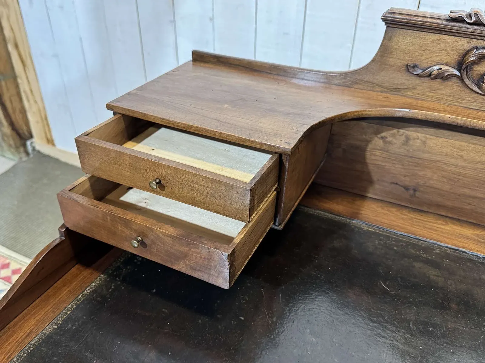 Louis XVI style desk from the late 19th century in walnut with a leather top.