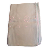 Old embroidered tablecloth in light green color