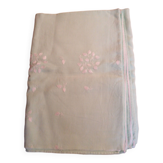 Old embroidered tablecloth in light green color
