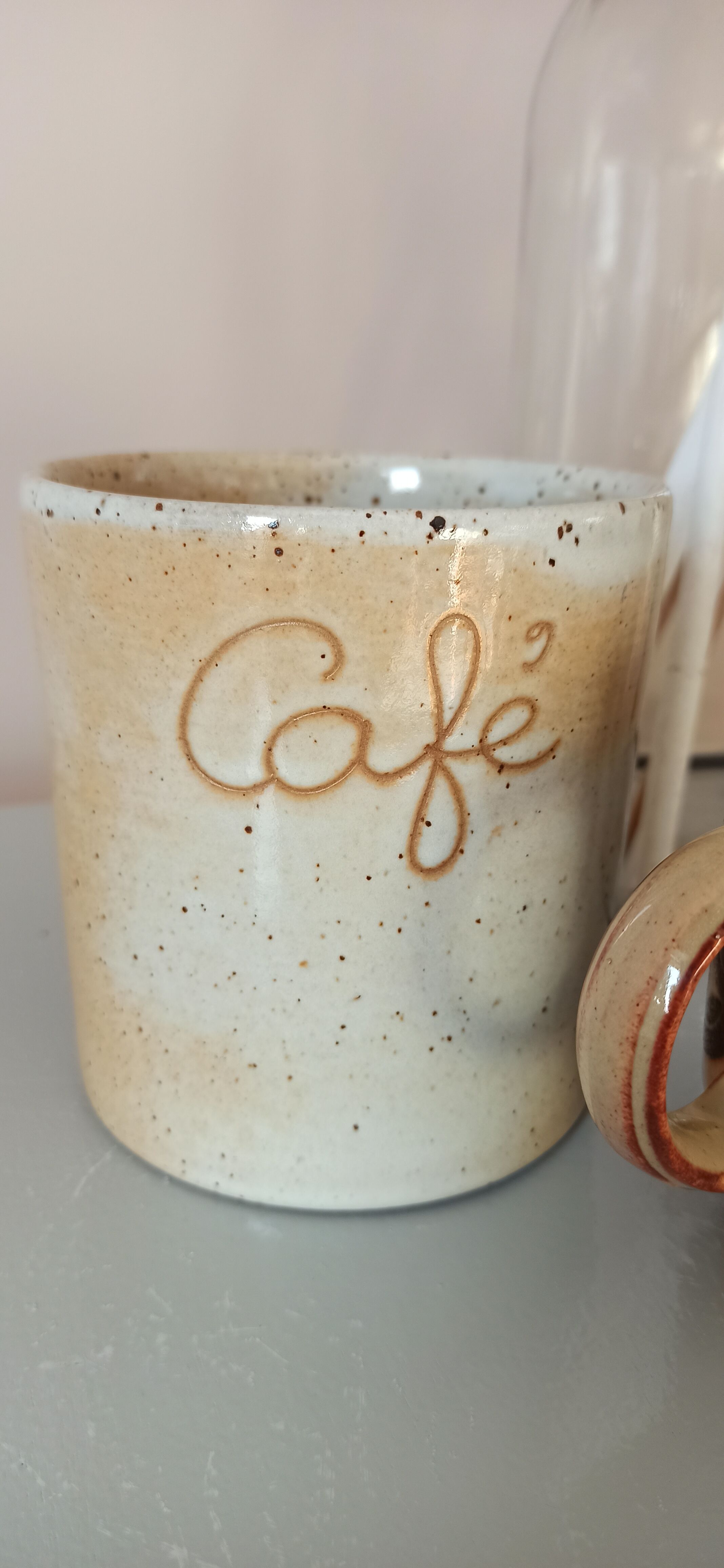 Coffee pot and mug cup in sandstone
