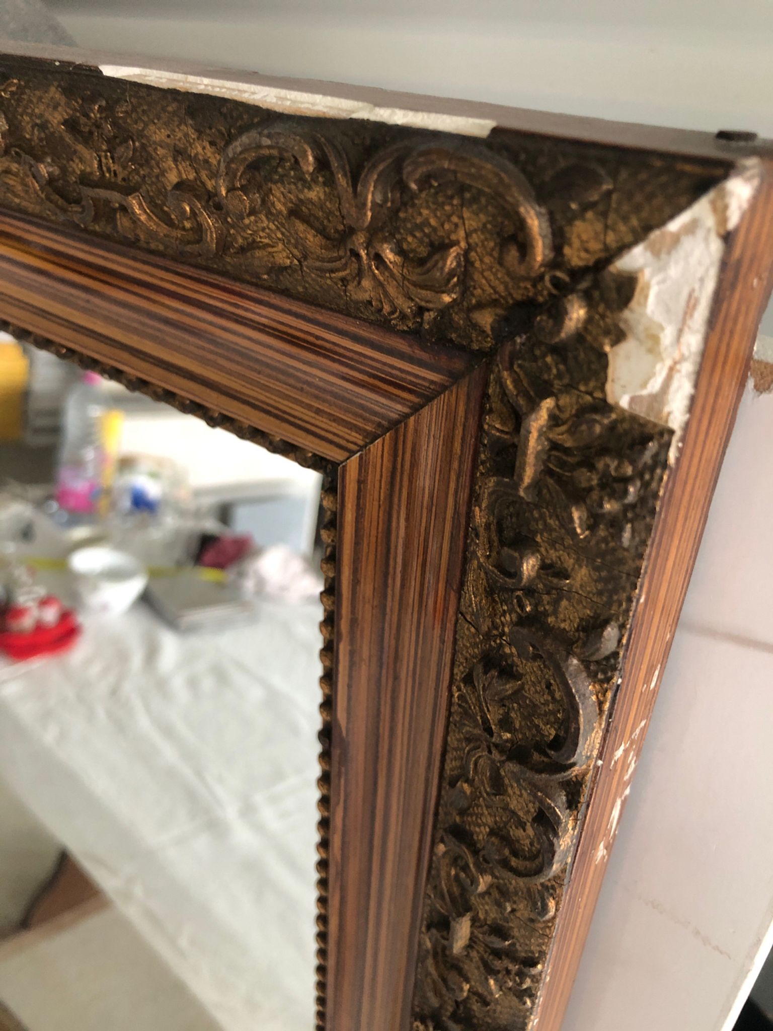 Old mirror with wooden frame and plaster moldings