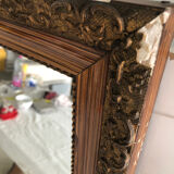 Old mirror with wooden frame and plaster moldings