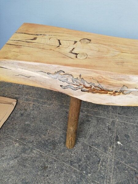 Big bench in solid rough wood very thick Brutalism