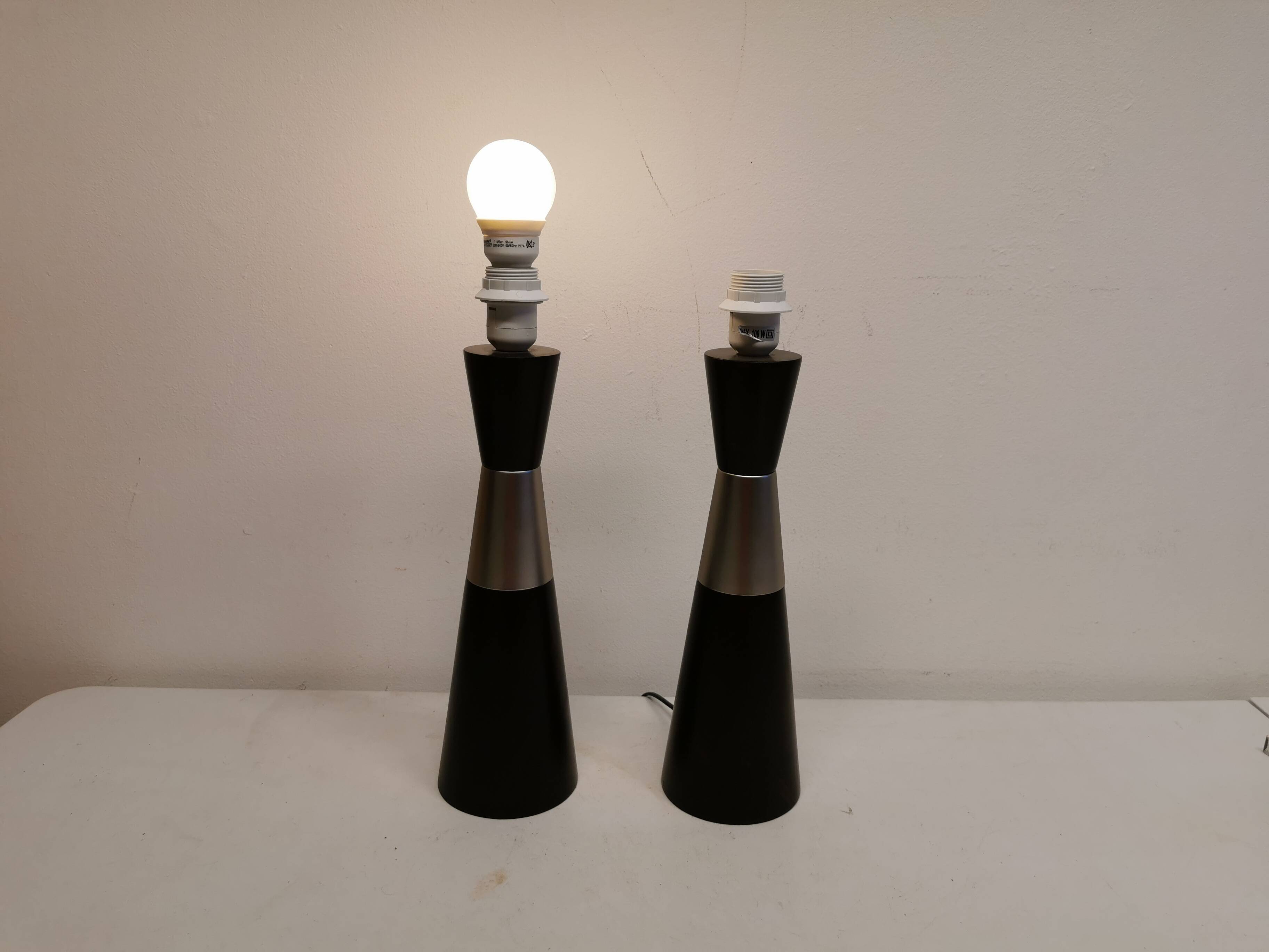 Two table lamps made of dark-stained wood with silver detail in the middle.