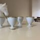 Set of 4 vintage egg cups in white porcelain with a gold rim.