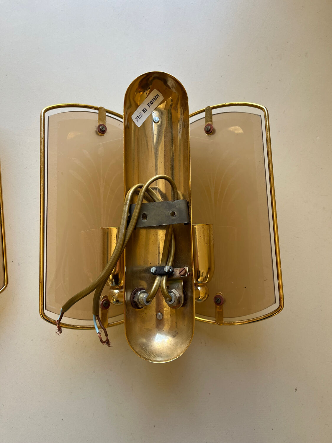 Pair of brass and smoked glass wall lights