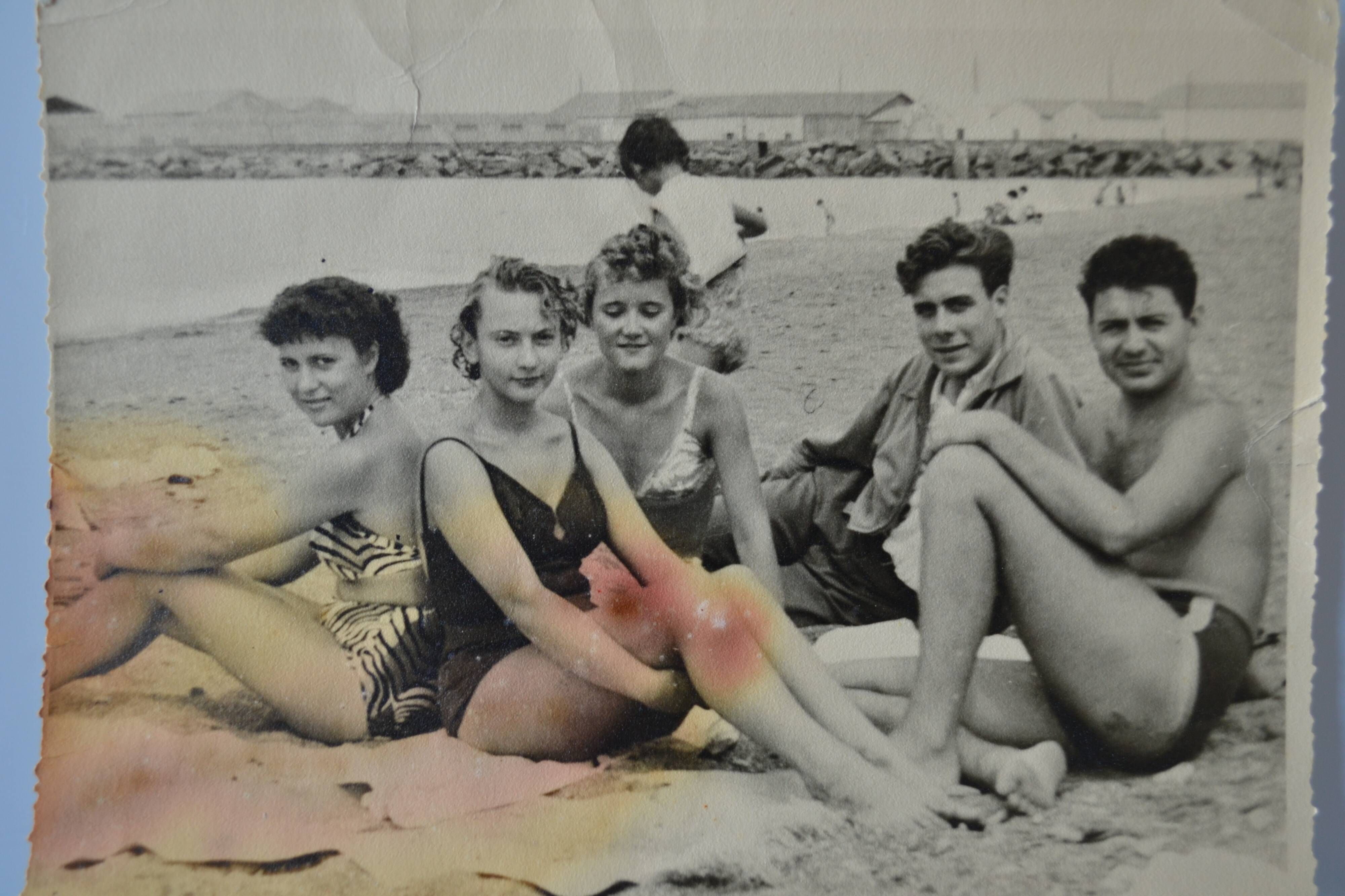 Old film photo circa 1950 the beach group of teenagers