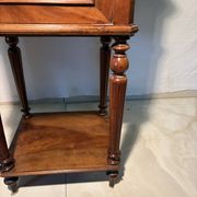 Antique wooden bedside table with turned legs.
