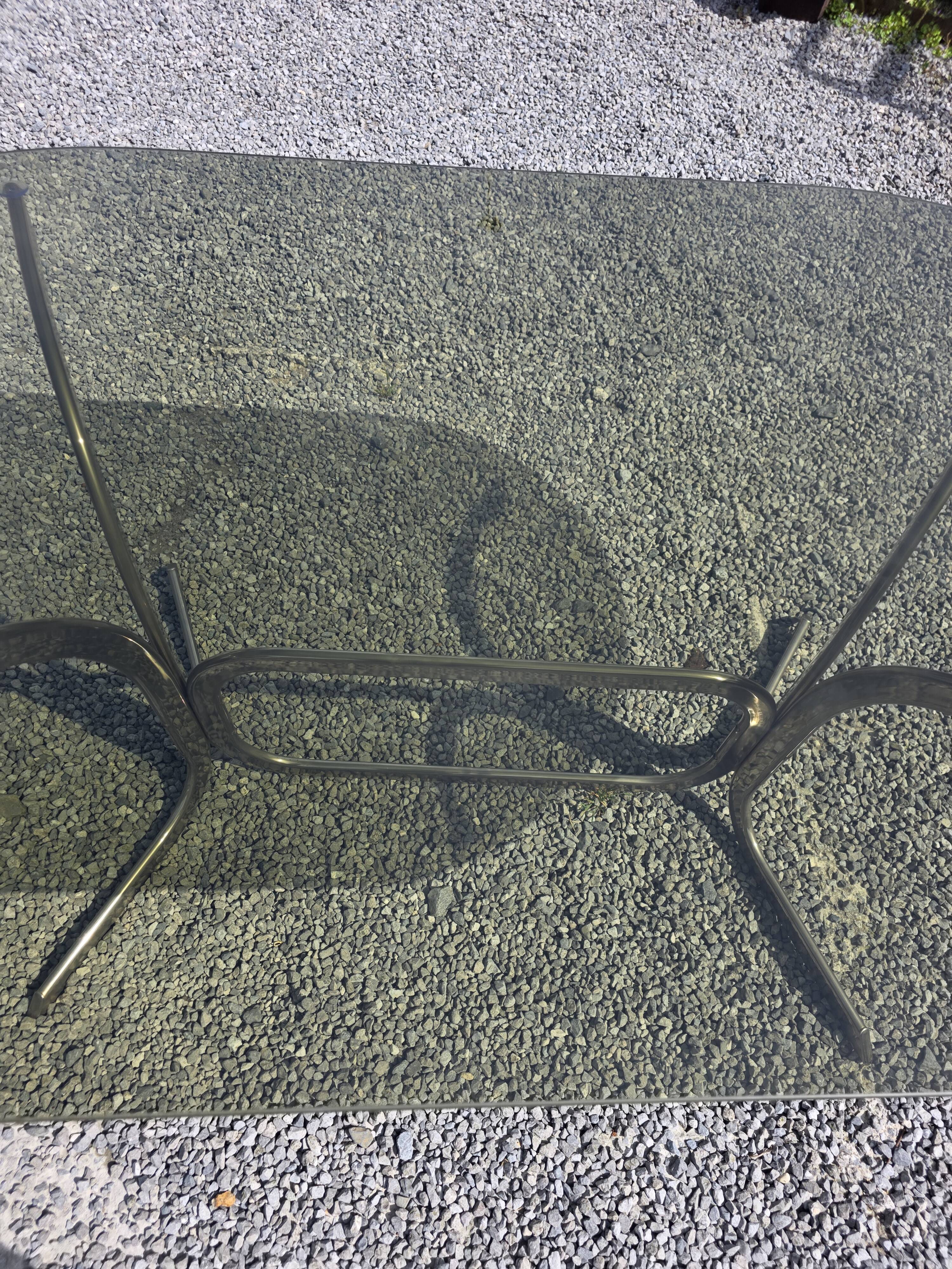 Silver metal table with smoked glass top from the 1970s.