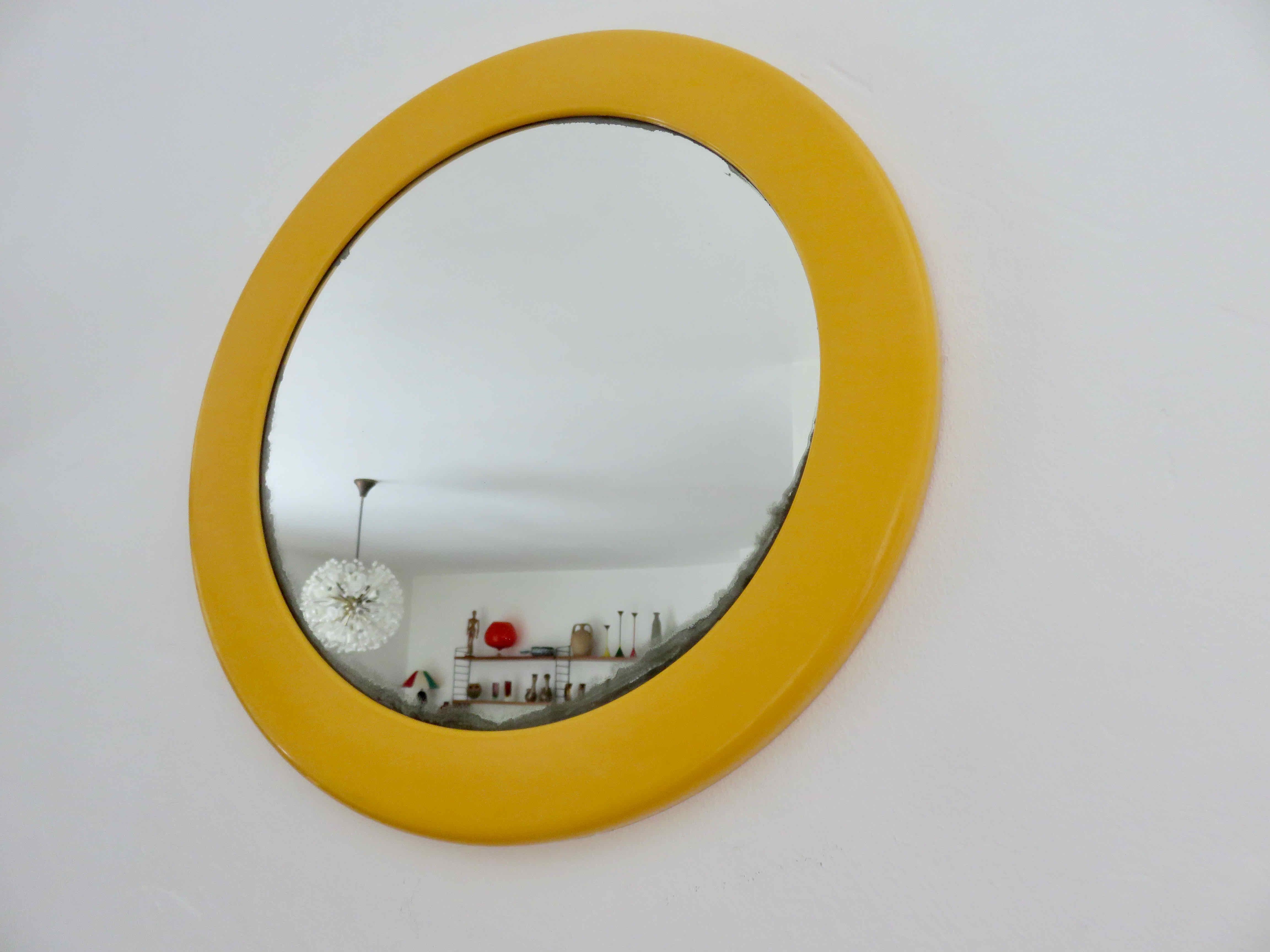 Round wall mounted mirror in yellow plastic 1970