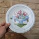 Plate with hand-painted flower bouquet on light blue background 25cm