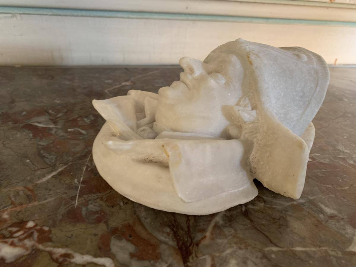 Marble sculpture, man's head in a hat.