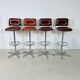 1970s chrome bar stools with cognac-colored faux leather upholstery