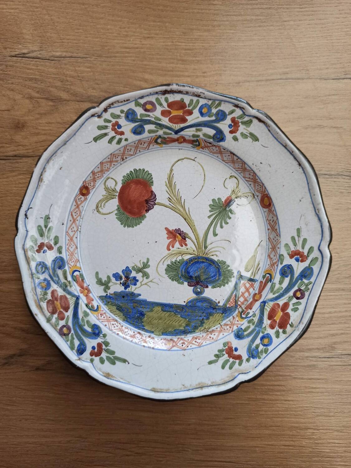 Eastern earthenware plate decorated with a ripe poppy flower