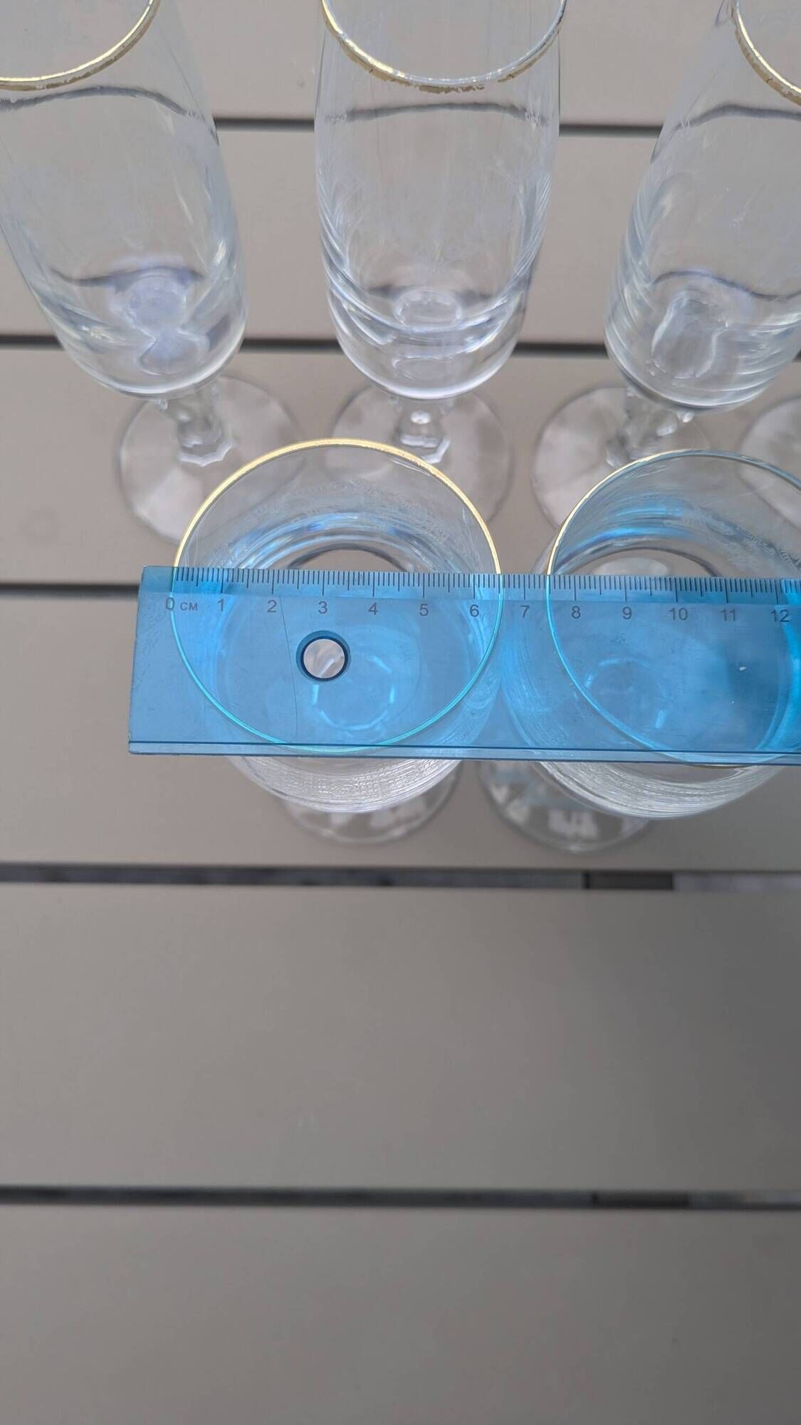 Set of 15 engraved crystal glasses with a gold rim.