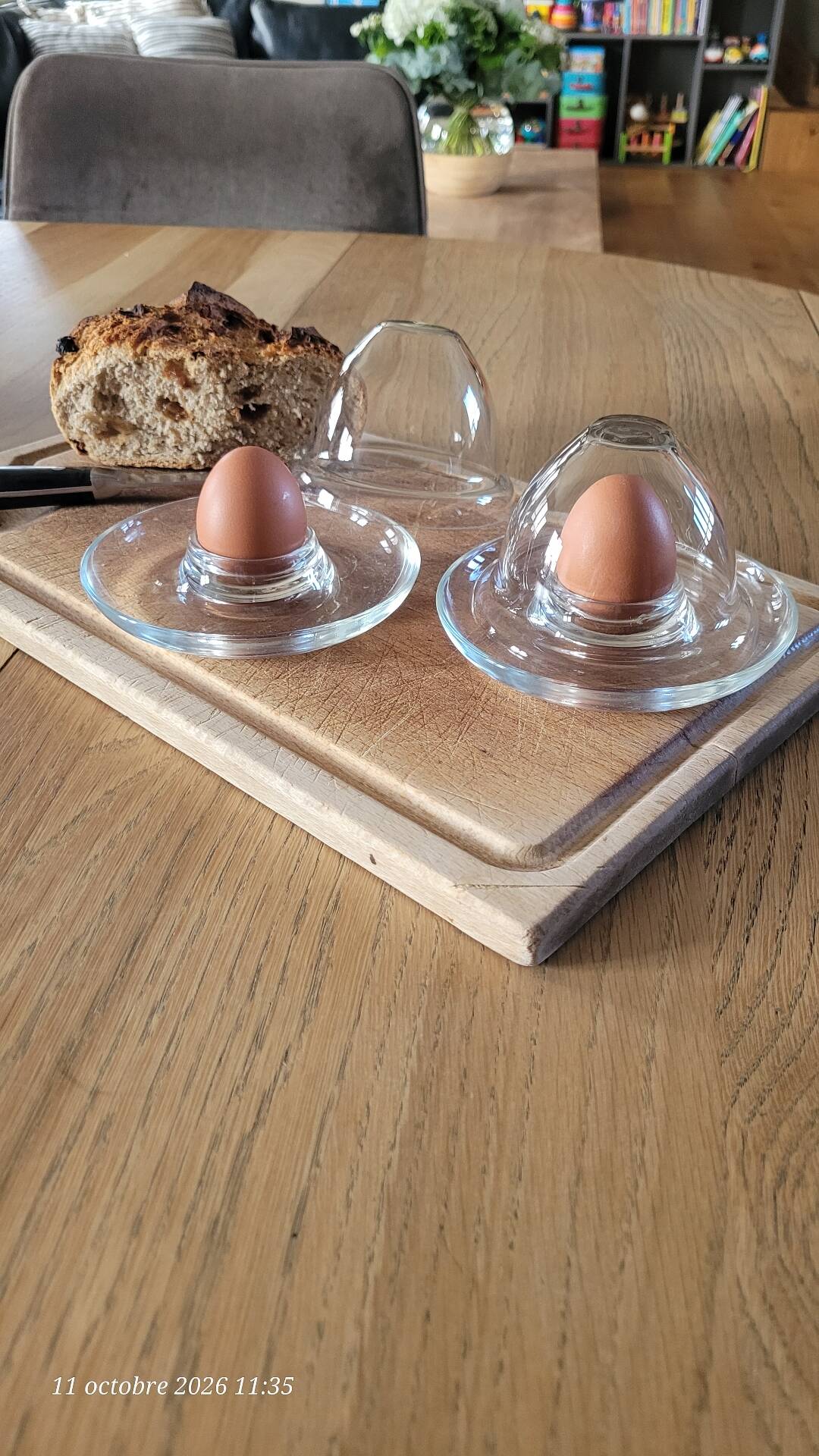 2 egg cups with matching glass cloches in transparent glass