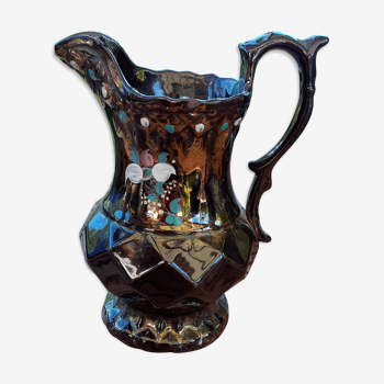 Old pitcher painted by hand, colors iridescent reflections