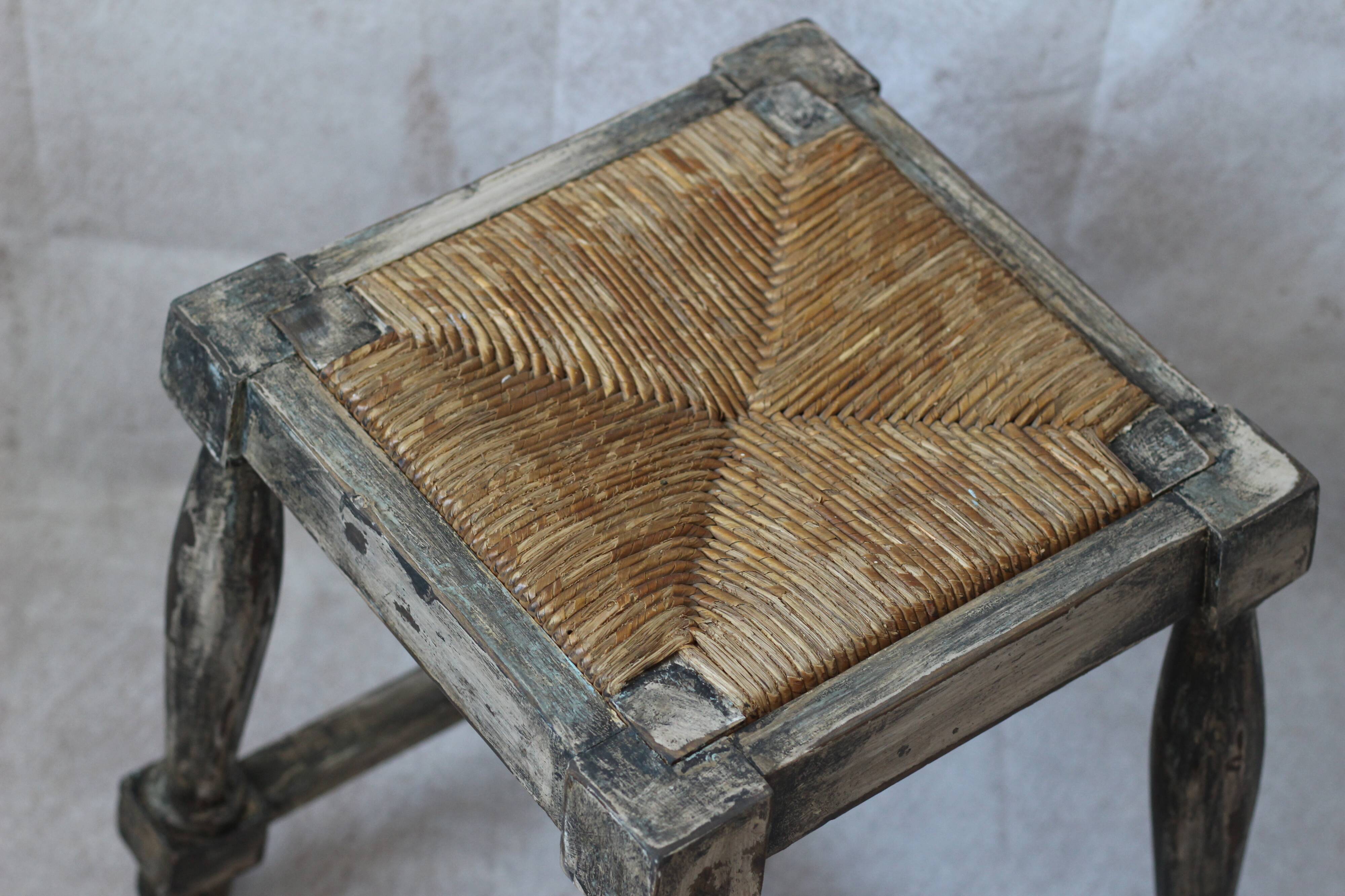 Patinated wooden stool with straw seat