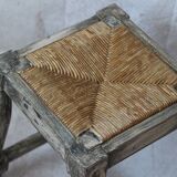 Patinated wooden stool with straw seat