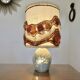 Ceramic lamp with double lighting and openwork design.