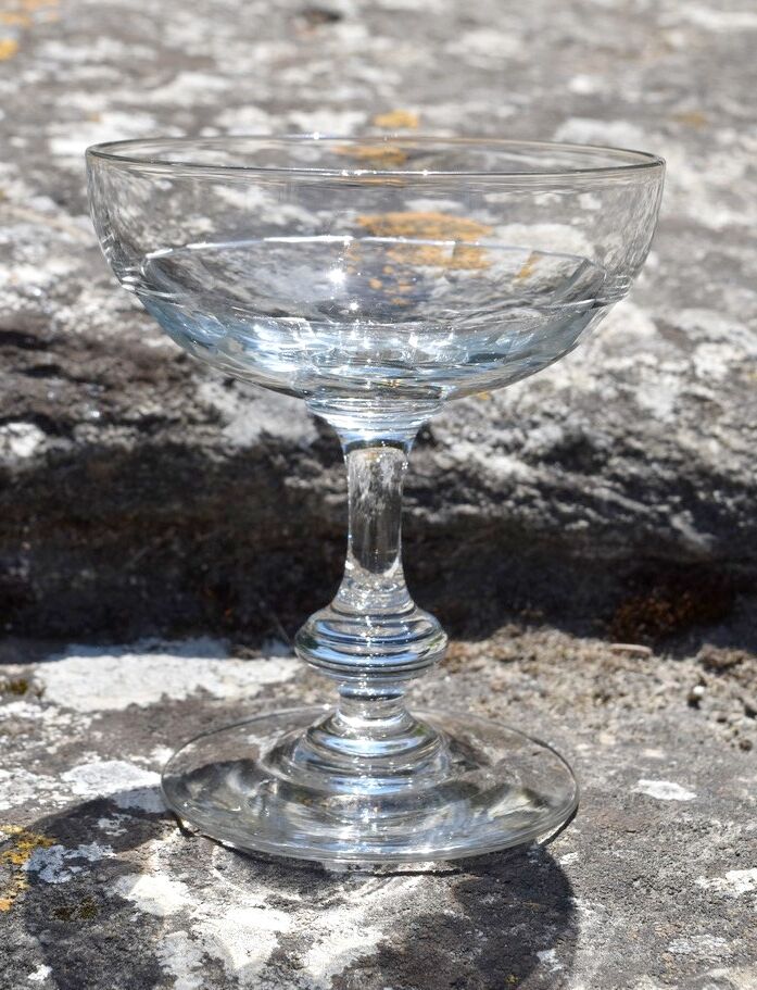 9 old champagne glasses in flat-waisted blown glass