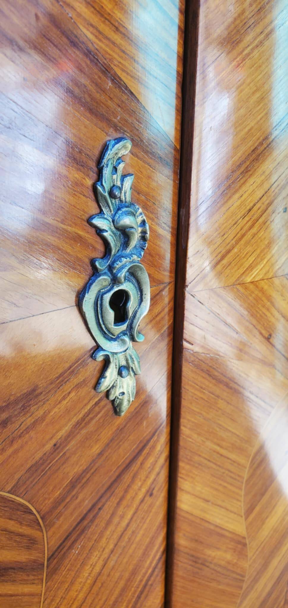 Two-door cabinet with marquetry floral design from the early 20th century.