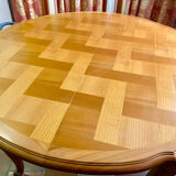Round extendable wooden table with glass top