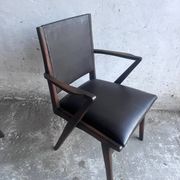Pair of sculptural mid-century armchairs in dark wood and brown upholstery.