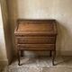 Charming antique oak secretary with drawers.