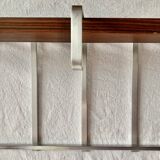 Vintage wall-mounted coat rack made of plywood and aluminum with hat rack