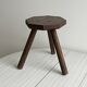 Small dark wooden tripod stool