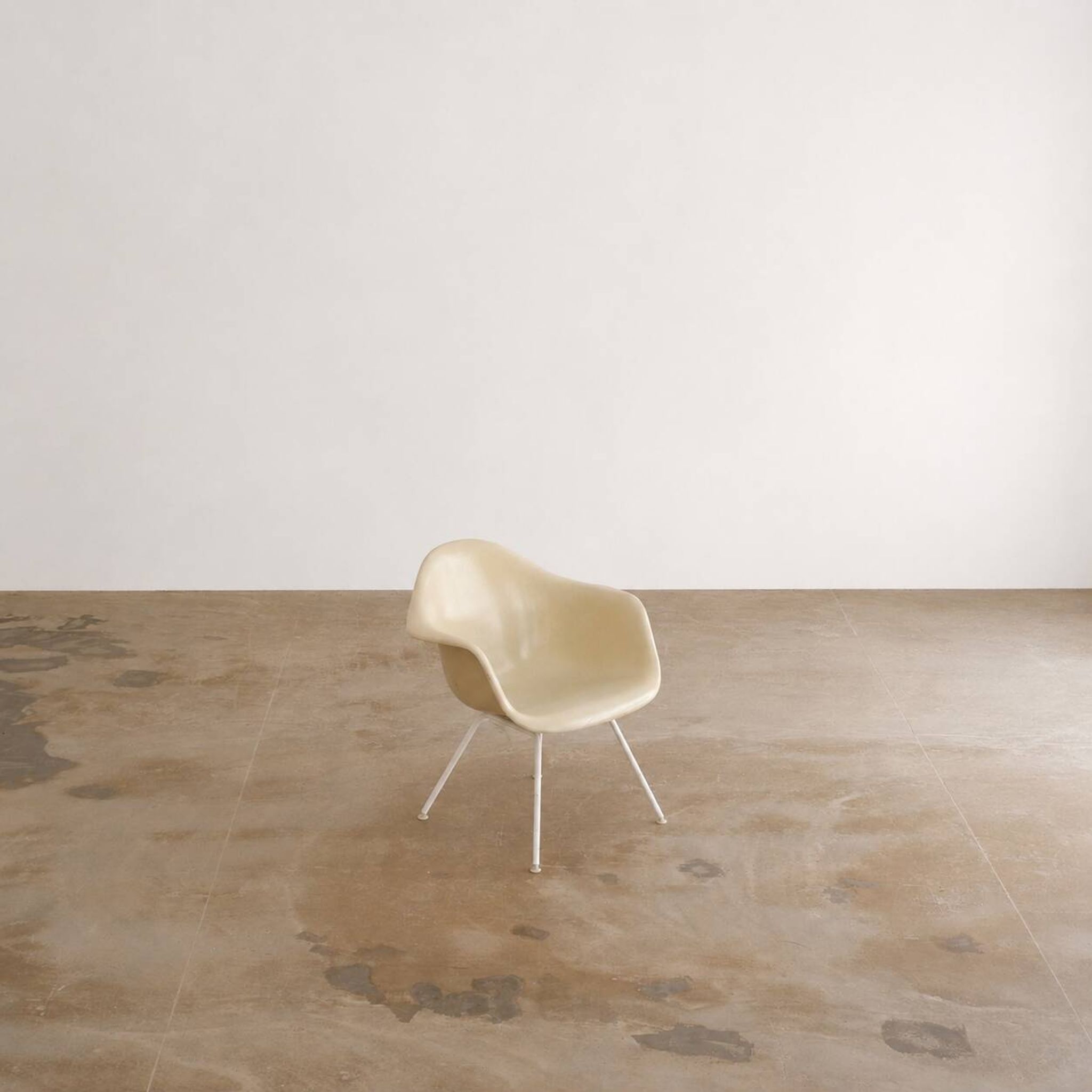Eames fiberglass armchair by herman miller with white lax base