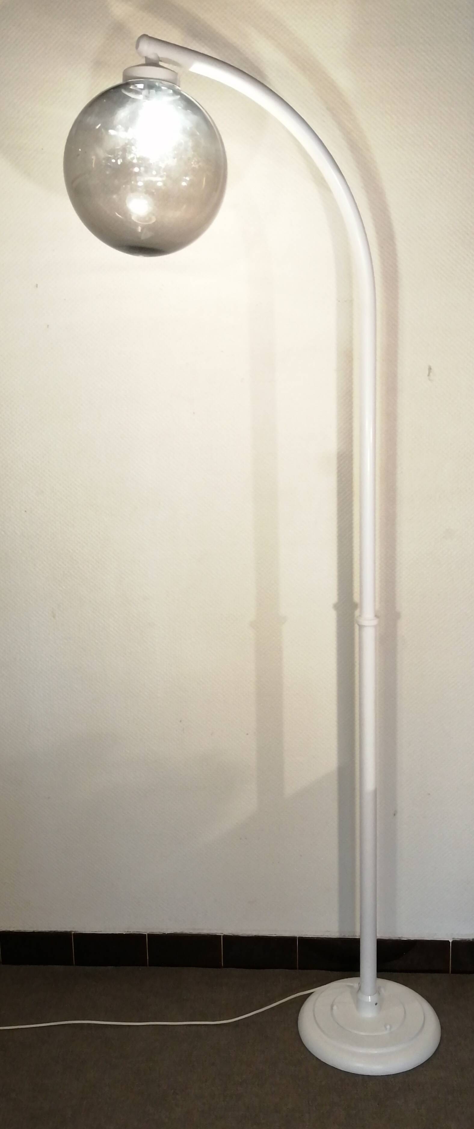 Adjustable metal floor lamp with its vintage smoked ball model from Roger Pradier 1970